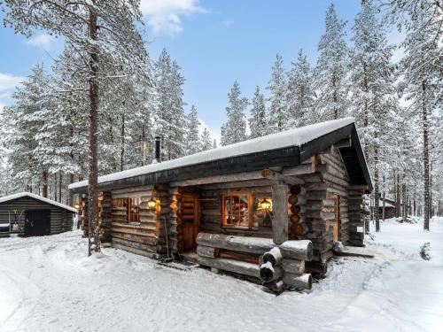 a log cabin in the snow in the woods at Holiday Home Karkelo by Interhome in Ylläsjärvi