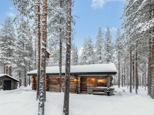 a log cabin in the woods in the snow at Holiday Home Karkelo by Interhome in Ylläsjärvi