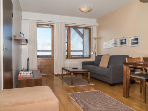 a living room with a couch and a table at Holiday Home Ylläs chalets a402 by Interhome in Ylläs