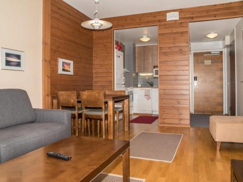 a living room and kitchen with a couch and a table at Holiday Home Ylläs chalets a402 by Interhome in Ylläs