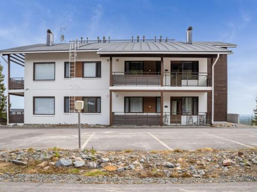 a large white building with a parking lot at Holiday Home Villa ylläs 201 by Interhome in Ylläs