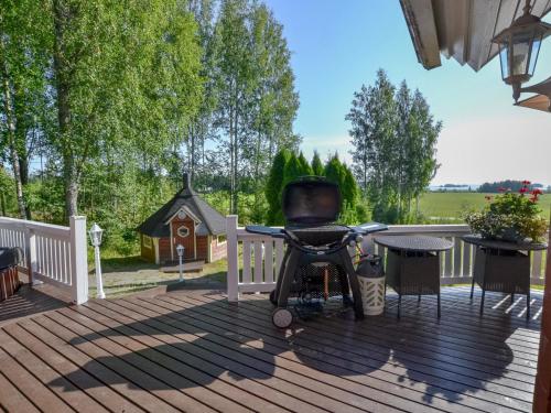 a chair sitting on the deck of a house at Holiday Home Kannelpirtti 2 by Interhome in Puromäki
