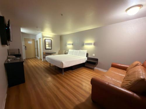 a large room with a bed and a couch at Americas Best Value Inn Apache Junction in Apache Junction