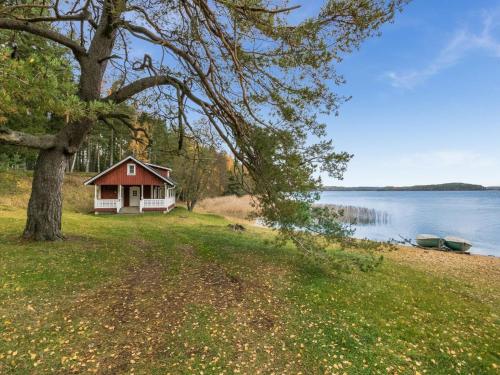 a small house on the shore of a lake at Holiday Home Satulinna by Interhome in Matildedal