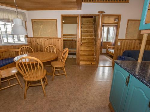 a kitchen and dining room with a table and chairs at Holiday Home Meritähti by Interhome in Matildedal