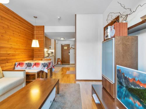 a living room with a couch and a tv at Holiday Home Ylläs chalets 2405 by Interhome in Ylläs