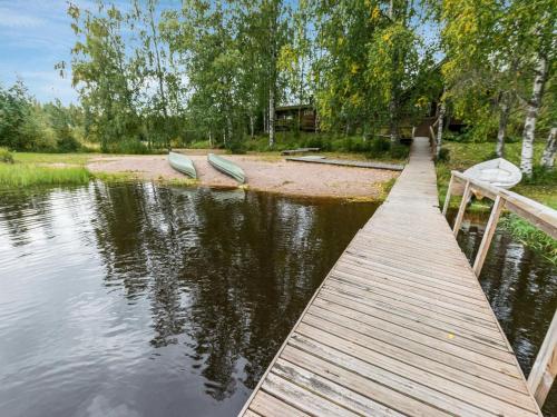 a dock with two boats on the shore of a lake at Holiday Home Koivuranta by Interhome in Jämijärvi