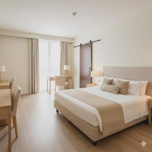 a large bedroom with a large bed and a table at Zamaria Beach Resort & Hotel in Sampong