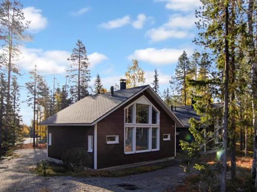 a small cabin in the woods with trees at Holiday Home Halla by Interhome in Levi