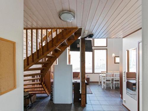a wooden staircase in a house with a dining room at Holiday Home Halla by Interhome in Levi