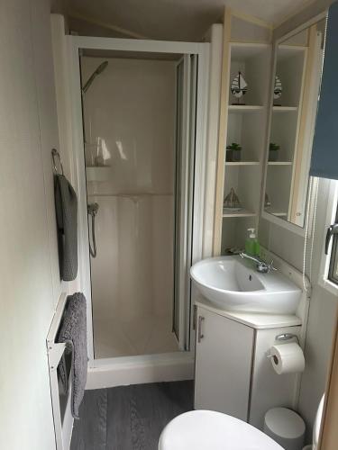 a bathroom with a shower and a sink at Holiday home 5 minutes from Porth beach in Newquay Bay Resort