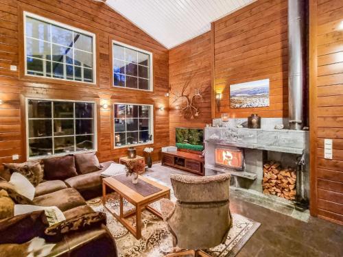 a living room with a couch and a fireplace at Holiday Home Arctic chalet by Interhome in Ylläsjärvi