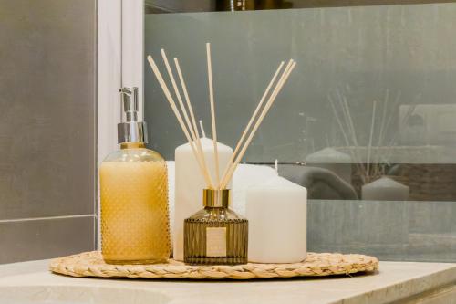 a table with two bottles of soap and bamboo sticks at Palau de la Musica Apartments in Barcelona