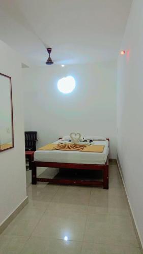 a bedroom with a bed in a white room at Krishna Guest House in Arambol