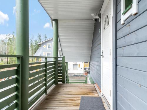 a wooden walkway leading to the front door of a house at Holiday Home Ylläs-eeli green house c2 by Interhome in Ylläsjärvi
