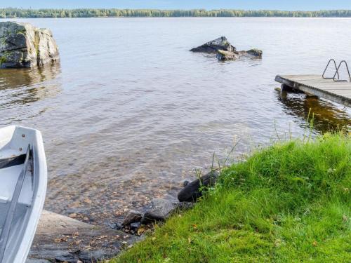 a boat parked next to a dock on a lake at Holiday Home Lomaranta by Interhome in Ruvaslahti