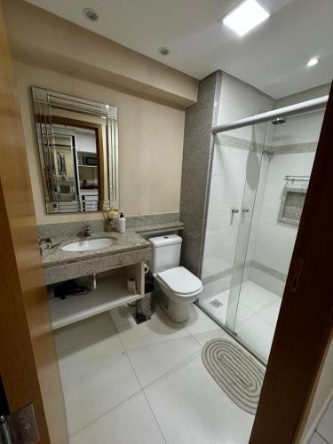 a bathroom with a toilet and a sink and a shower at Flat no Vivence Suites em Palmas in Palmas
