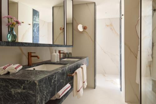 a bathroom with a sink and a mirror at Don Carlos Marbella in Marbella