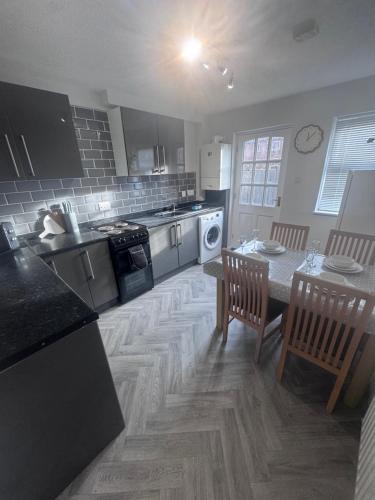 a kitchen with a table and chairs and a counter top at Oakleigh Way, Carlisle - 2 Bedroom, sleeps 4, Fully furnished in Carlisle