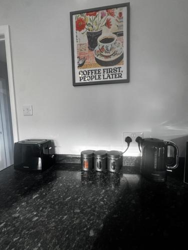a counter top with three coffee pots and a picture on the wall at Oakleigh Way, Carlisle - 2 Bedroom, sleeps 4, Fully furnished in Carlisle