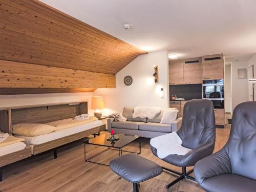 a living room with a bed and a couch at Apartment Eiger Residence Apt-A-425 by Interhome in Wengen