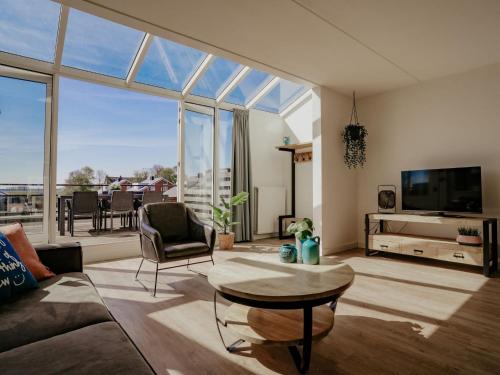 a living room with a couch and a table at Apartment Oostergeest by Interhome in Uitgeest