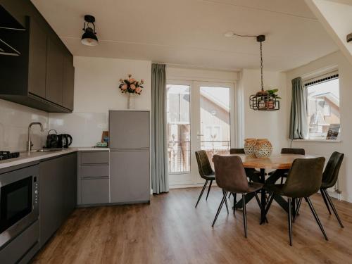 a kitchen and dining room with a table and chairs at Apartment Oostergeest by Interhome in Uitgeest