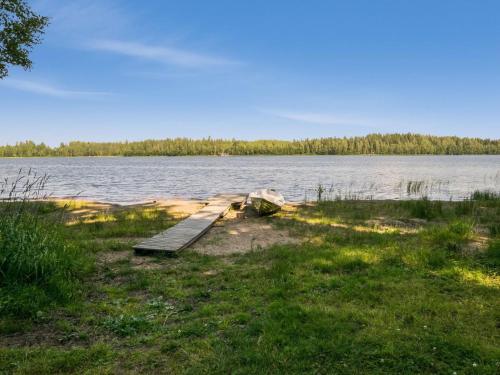 a dock on the side of a body of water at Holiday Home Lemmenmaja by Interhome in Paatela