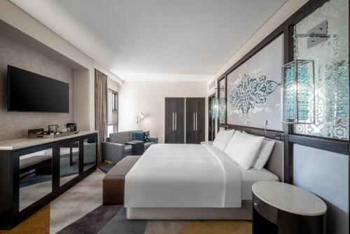 a hotel room with a bed and a desk at Rotana Jabal Omar Makkah in Mecca