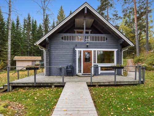 a tiny house with a porch and a deck at Holiday Home Mykkylä by Interhome in Niemi