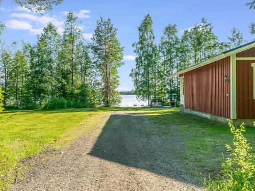 an empty driveway next to a red building at Holiday Home Laavusranta by Interhome in Kantala