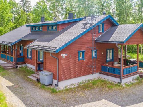 a large wooden house with a gambrel roof at Holiday Home Asterix by Interhome in Tahkovuori