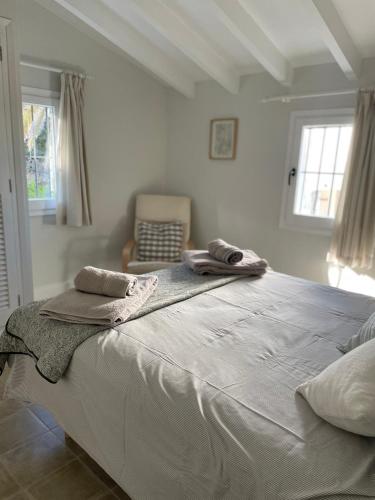 a bedroom with a large bed with towels on it at Casita Molivent in Parcent
