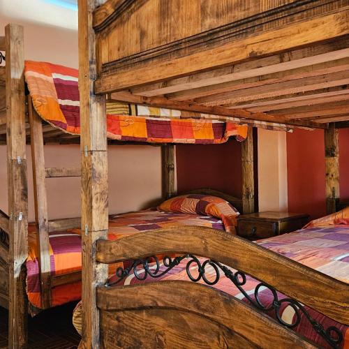 a bedroom with two bunk beds in a room at Bolivian Heights Hostel in La Paz