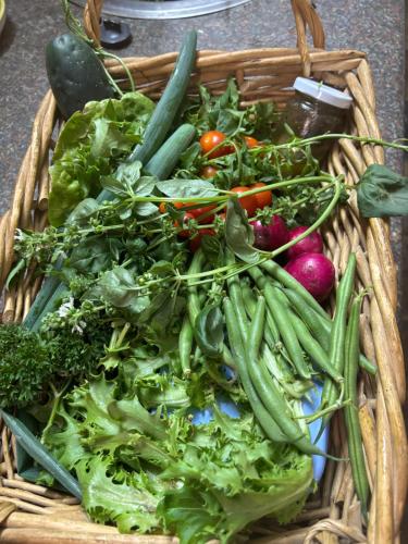 a basket filled with lots of vegetables on a table at Shepherd's Cottage Smithfield in Smithfield