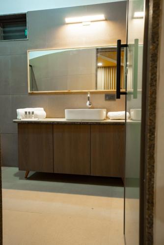 a bathroom with a sink and a mirror at Aatman Forest Resort - A Luxury Stay in Sasan Gir in Sasan Gir