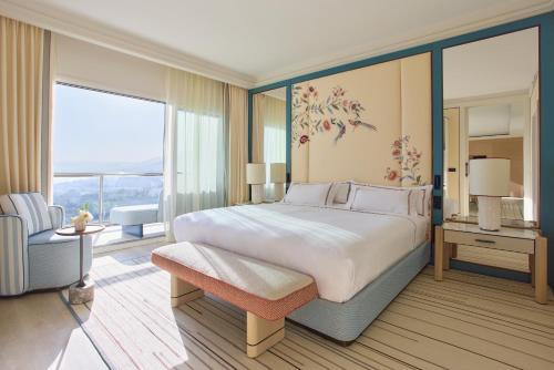 a bedroom with a large bed and a large window at Don Carlos Marbella in Marbella