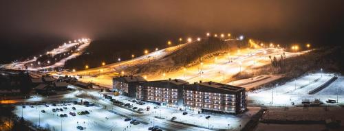 a city at night with lights on a mountain at Break Sokos Hotel Himos in Jämsä