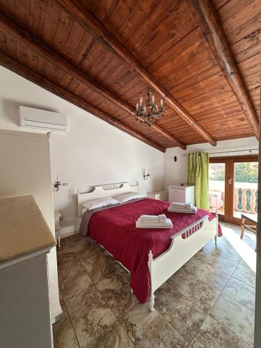 a bedroom with a large bed with a red bedspread at Bed and Breakfast Bellavista in Olmedo