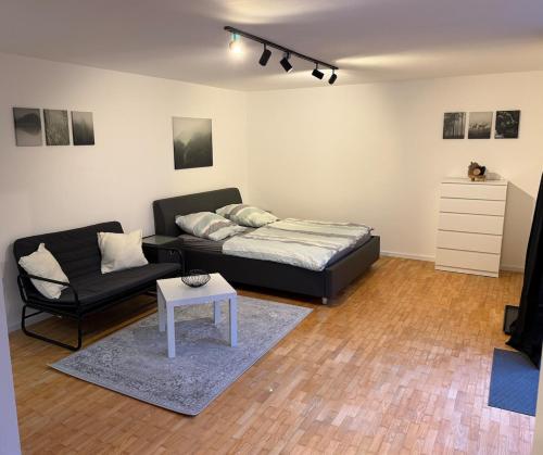 a living room with a bed and a couch at Ferienwohnung Engels in Olpe