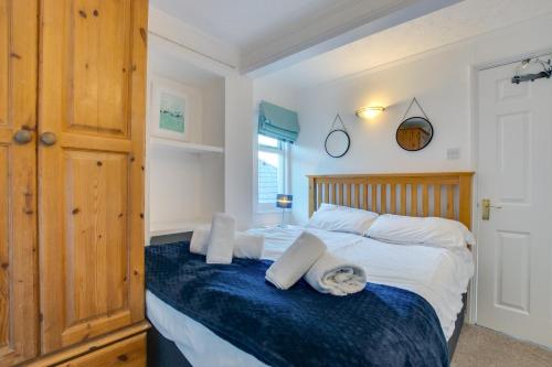 a bedroom with a large bed with white sheets and blue blanket at 1 Bed in St. Ives oc-pc716a in St Ives