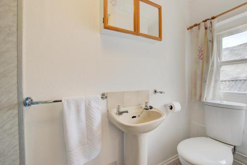 a white bathroom with a toilet and a sink at 1 Bed in St. Ives oc-pc716a in St Ives