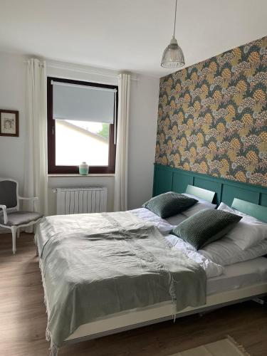 a bedroom with a large bed and a window at Gastwerk Waldfrieden in Gießen