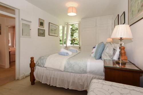 a bedroom with two beds and a table and a lamp at 2 Bed in Landford oc-l31877 in Landford