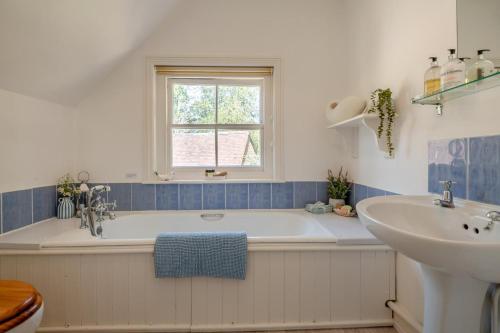 a bathroom with a tub and a sink at 2 Bed in Landford oc-l31877 in Landford