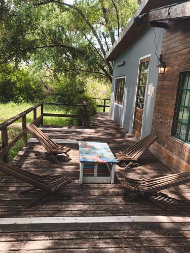 a table and two chairs on a wooden deck at Casa Chichipio in Tigre