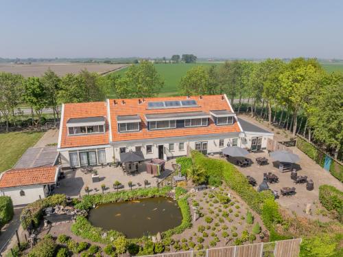 an aerial view of a house with a garden at B&B Plompetorenzicht in Burgh Haamstede