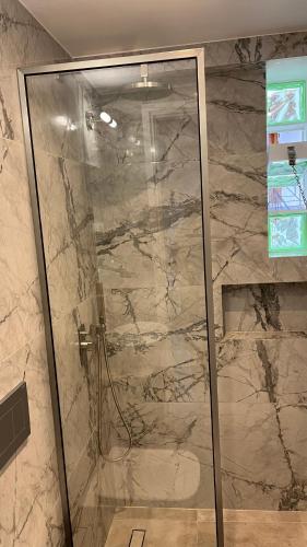 a shower with a glass door in a bathroom at Angelos House Deluxe Apartments in Skiathos