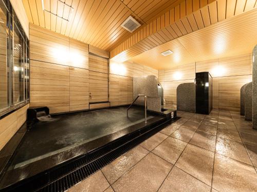 a empty room with chairs in a room with wooden walls at APA Hotel Osaka Temmabashi Ekimae in Osaka