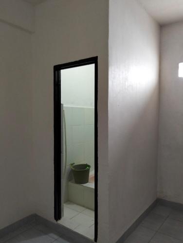a mirror in a room with a sink and a toilet at Penginapan amalia in Soreang